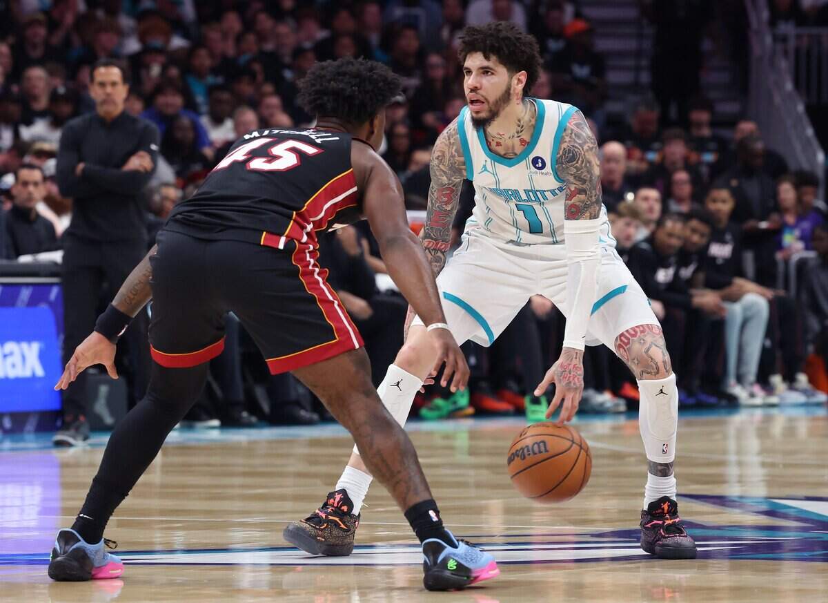Charlotte Hornets guard LaMelo Ball, right, brings the ball up the court in a game against the Miami Heat at Spectrum Center in Charlotte on April 14, 2026.