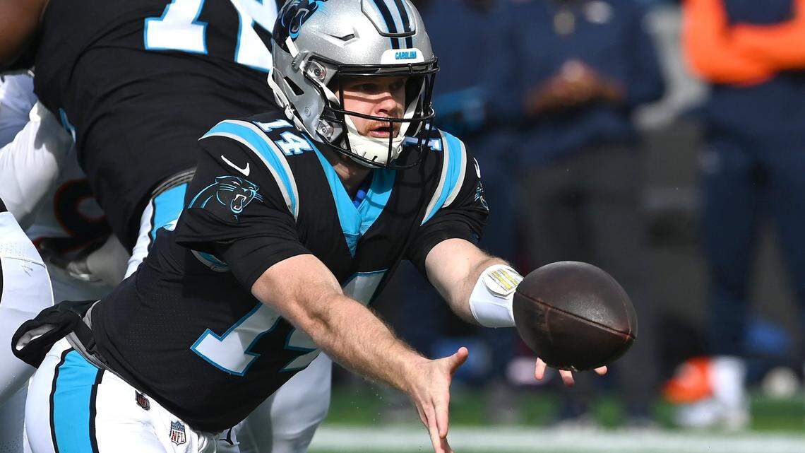 Carolina Panthers quarterback Sam Darnold pitches the ball out to a running back during first half action against the Denver Broncos on Sunday, November 27, 2022 at Bank of America Stadium in Charlotte, NC.