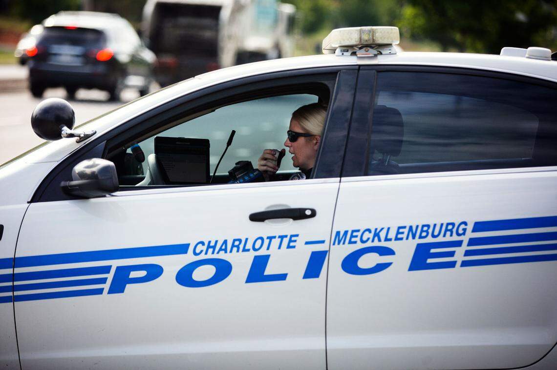 CMPD Officer Amanda Walters radios to officers working down the street as part of a speeding enforcement operation on Freedom Drive.
