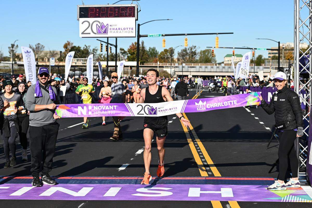 Adam Jones crosses the finish line to win the 20th annual Novant Health Charlotte Marathon, on Saturday, Nov. 16, 2024, in Charlotte