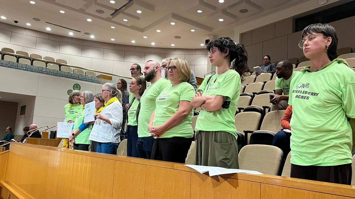 Steeleberry Acres residents stand in Charlotte’s City Council chambers, listening to the decision to remove part of the historic landmark status of the Steele Creek Presbyterian Church.