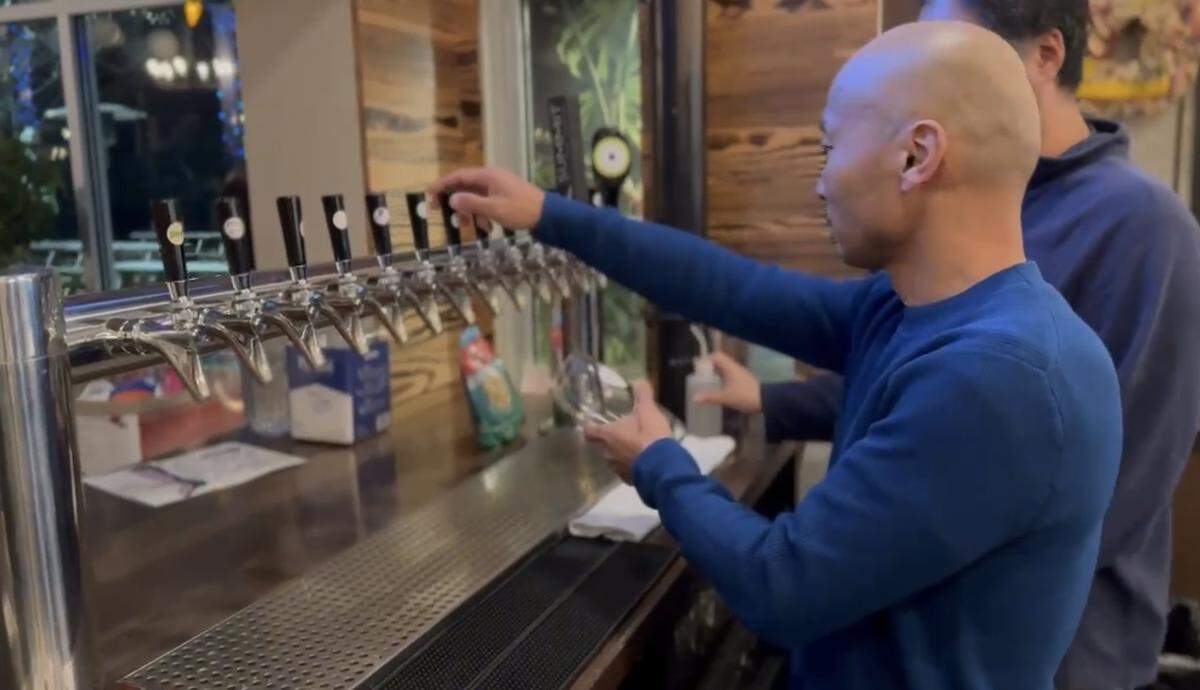 Théoden Janes gets ready to pour his first glass of the beer he created with Vaulted Oak Brewing.