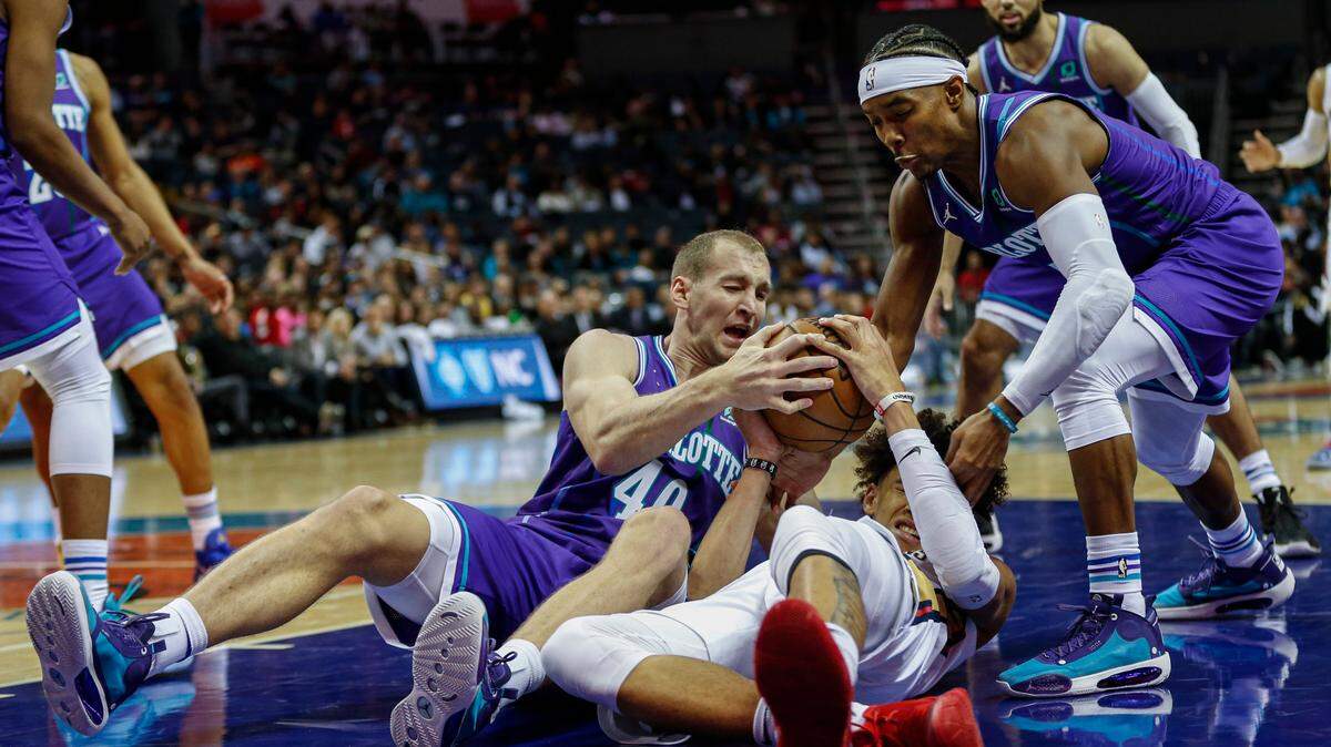 Hornets Cody Zeller and Devonte Graham battle New Orleans Pelicans center Jaxson Hayes in the Hornets 115-110 loss Saturday night. Charlotte committed almost two dozen turnovers and went cold from the field in the fourth quarter.