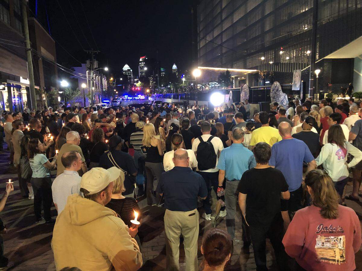People gather at the East/West Boulevard station Monday night in Charlotte to remember Iryna Zarutska, who was killed on Aug. 22.