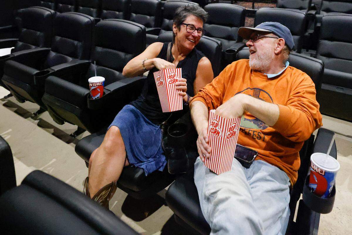Lisa Lackey and Michael Lackey eat popcorn and test the new seats at the Independent Picture House..