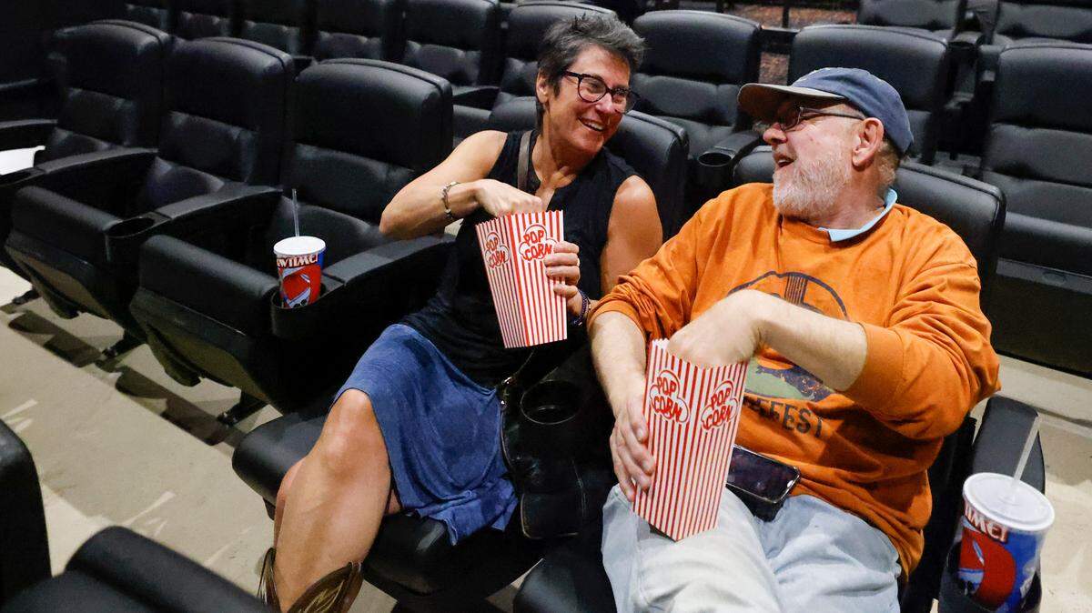Lisa Lackey, left, and Michael Lackey, both of Charlotte, N.C., eat popcorn at The Independent Picture House in this Charlotte Observer file photo.