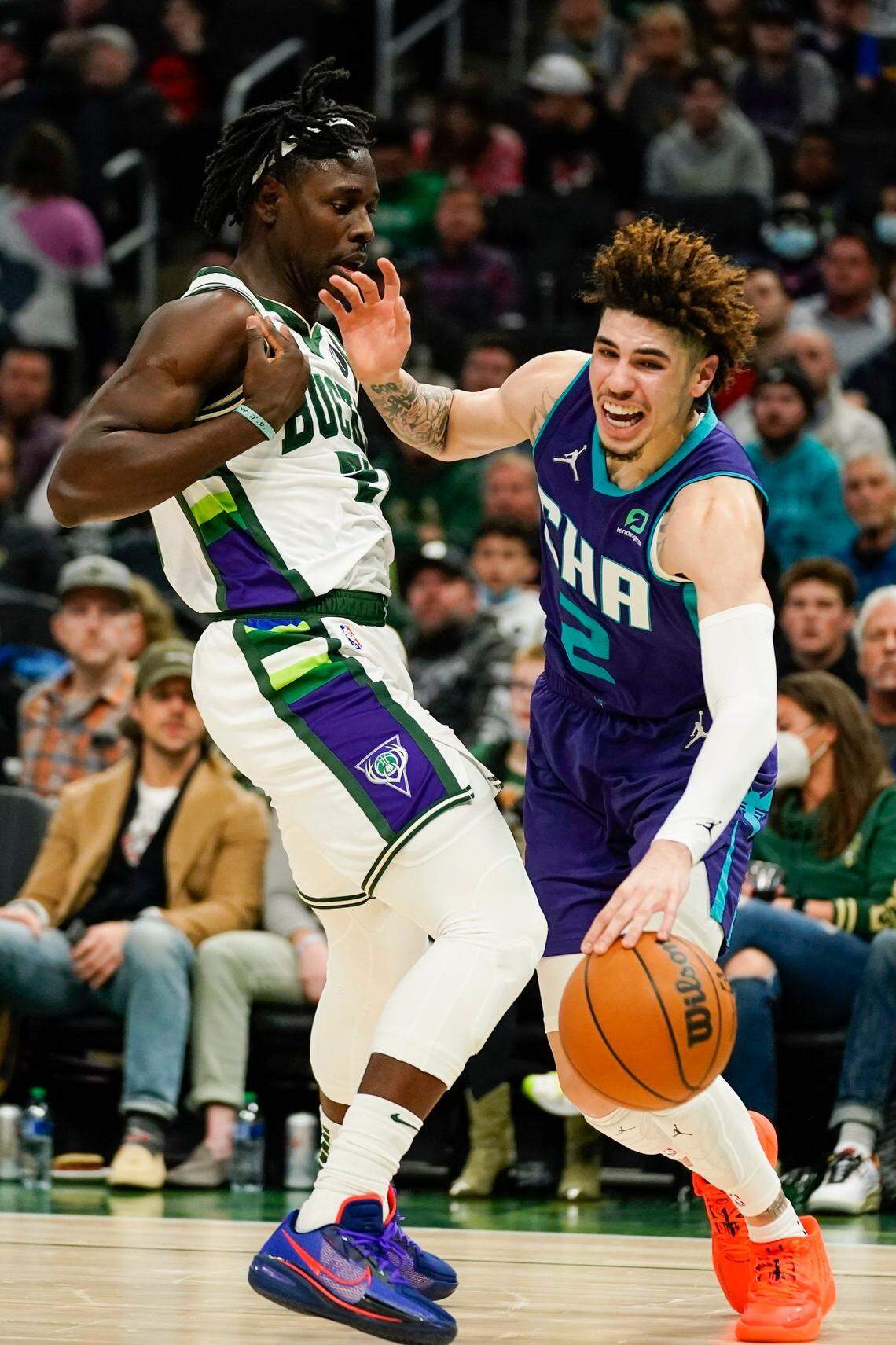 Charlotte Hornets’ LaMelo Ball tries to get past Milwaukee Bucks’ Jrue Holiday during the first half of an NBA basketball game Wednesday, Dec. 1, 2021, in Milwaukee. (AP Photo/Morry Gash)