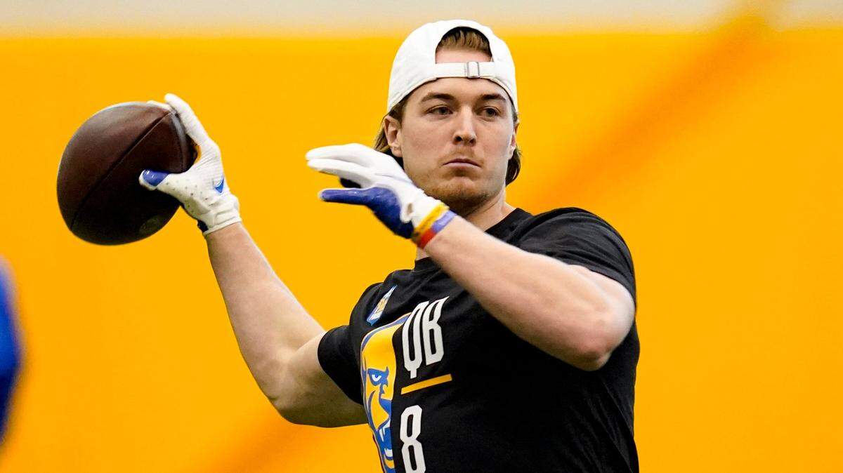 Quarterback Kenny Pickett (8) goes through passing drills during Pittsburgh’s football pro day , Monday, March 21, 2022, in Pittsburgh. (AP Photo/Keith Srakocic)