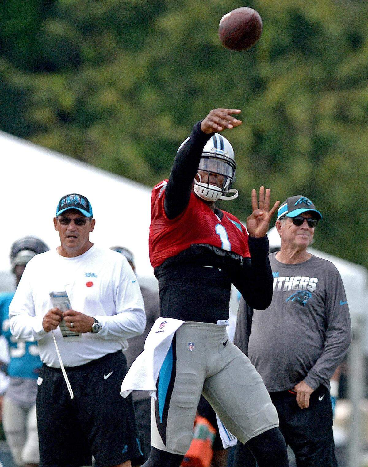 Carolina Panthers quarterback Cam Newton throws during Wednesday’s workout in front of coach Ron Rivera and general manager Marty Hurney. Newton told reporters Thursday that his rehab from offseason shoulder surgery is still a work in progress, even though he feels good.