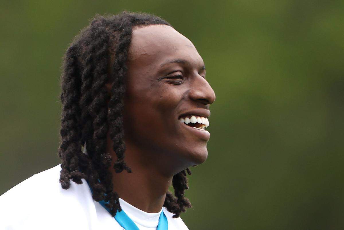 Carolina Panthers cornerback Jaycee Horn smiles as he walks to training camp practice on Thursday, July 25, 2024.