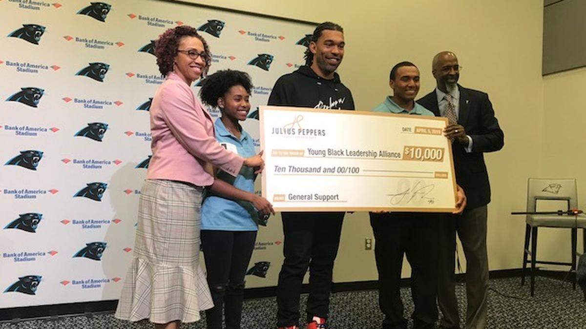 Former Carolina Panthers defensive end Julius Peppers, who announced his retirement in January, donated three separate checks of $10,000 each to three charities, including the Young Black Leadership Alliance.