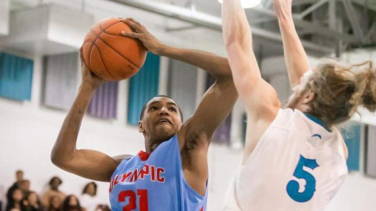 Olympic High’s Alijay Terry goes to the basket at Concord Cox Mill High Saturday