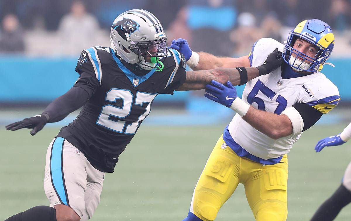Carolina Panthers Isaiah Simmons, left, pushes Los Angeles Rams linebacker Troy Reeder, right, aside on a kickoff on Nov. 30, 2025, at Bank of America Stadium in Charlotte. The Panthers defeated the Rams 31-28.