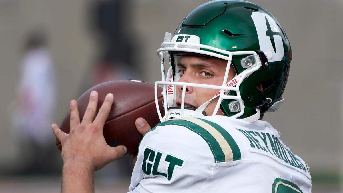 Charlotte quarterback Chris Reynolds warms up on the sidelines during the first half of an NCAA college football game against Illinois Saturday, Oct. 2, 2021, in Champaign, Ill. (AP Photo/Charles Rex Arbogast)