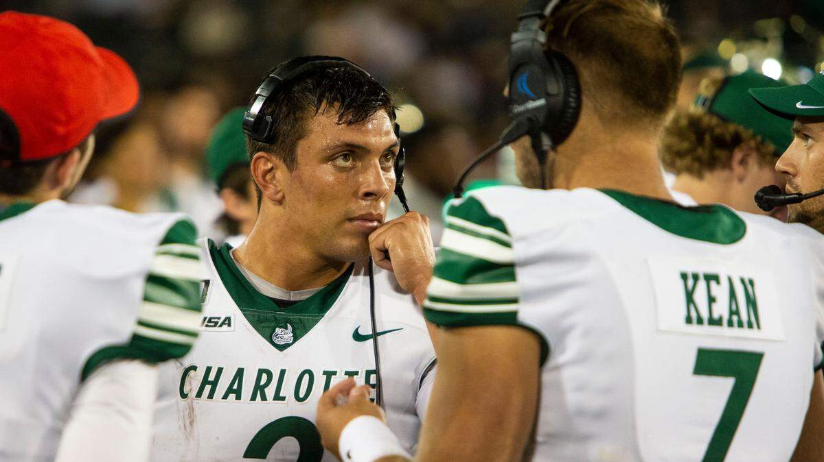 Charlotte’s Chris Reynolds (left) and Brett Kean strategize   during the season opener against Gardner-Webb.
