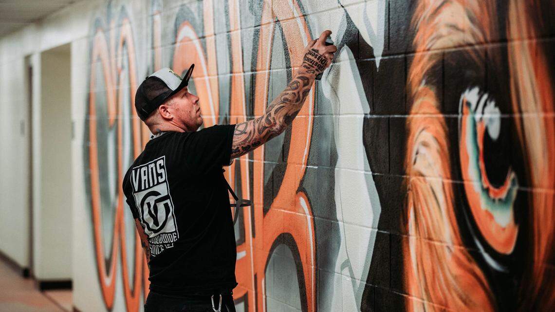 In cans of spray paint, he found hope. Now, Charlotte is hungry for his murals and his message.
