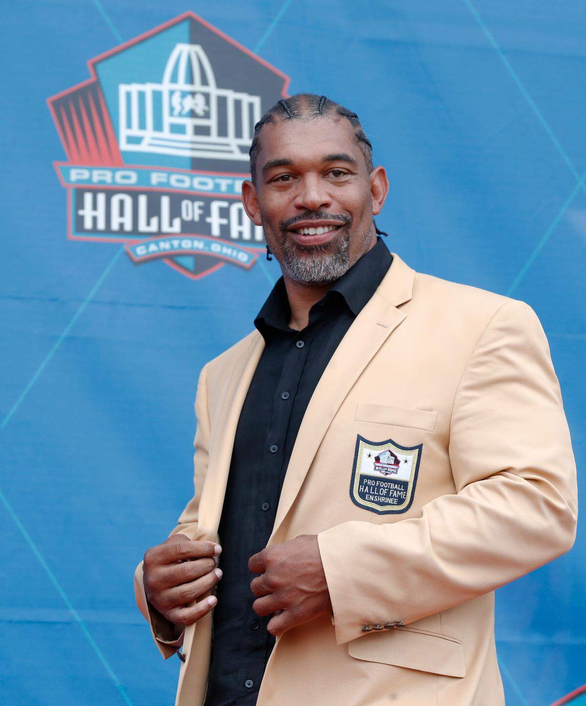 Aug 3, 2024; Canton, OH, USA; Julius Peppers during his induction into the Pro Football Hall of Fame at the enshrinement ceremony at Tom Benson Hall of Fame Stadium. Mandatory Credit: Charles LeClaire-USA TODAY Sports