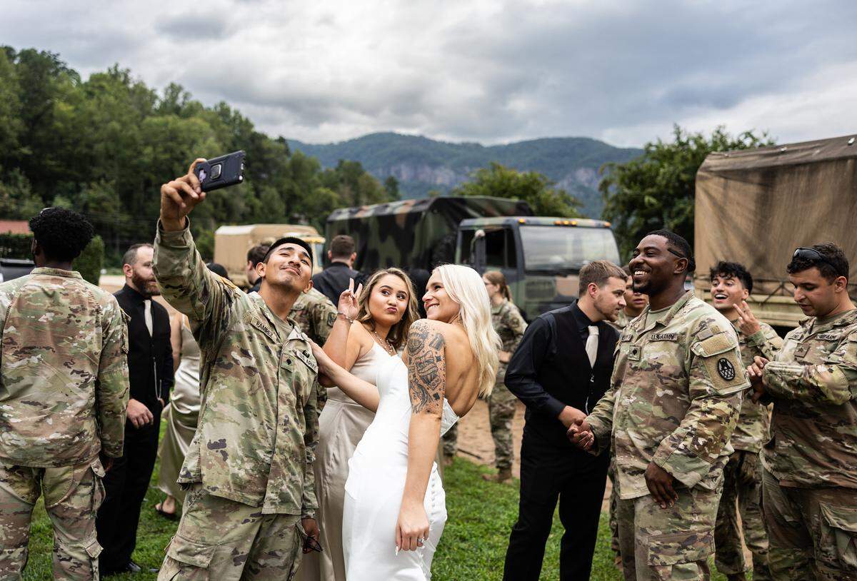 The North Carolina National Guard stops to congratulate the newlyweds, Sereyna and her husband Gavin Walker in Lake Lure, N.C., on Saturday, Sept. 28.