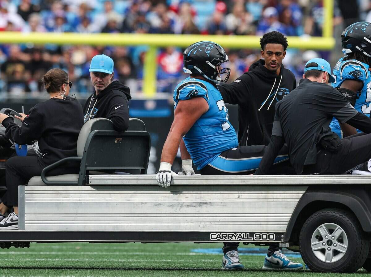 Panthers quarterback Bryce Young consoles offensive lineman Brady Christensen as he is carted off the field after suffering an injury during the game against the Bills at Bank of America Stadium in Charlotte, NC on Sunday, October 26, 2025.