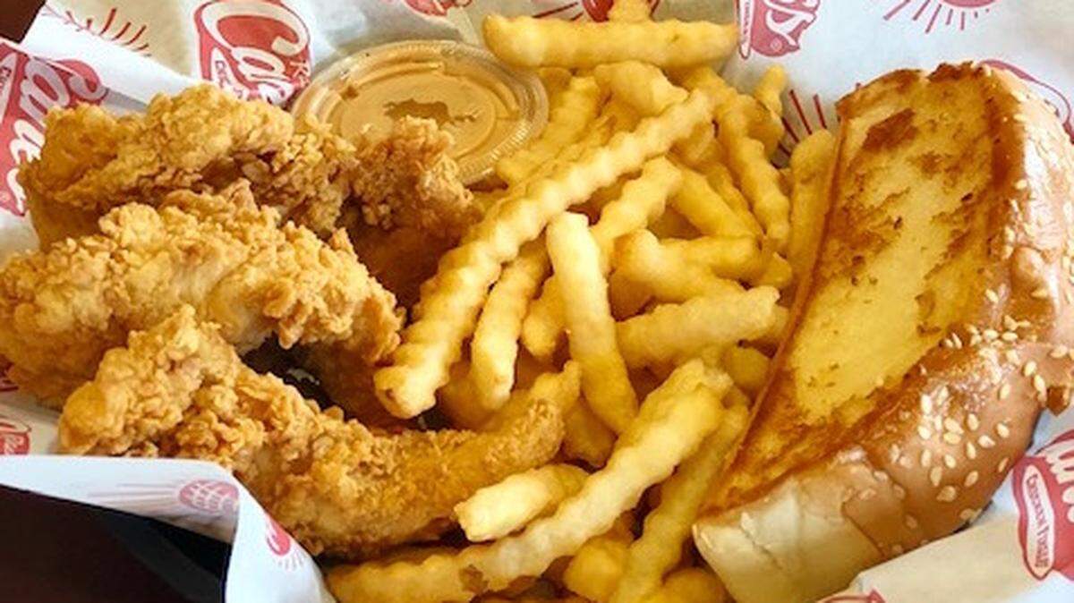 Raising Cane’s chicken fingers, fries and Texas toast sit in a basket.