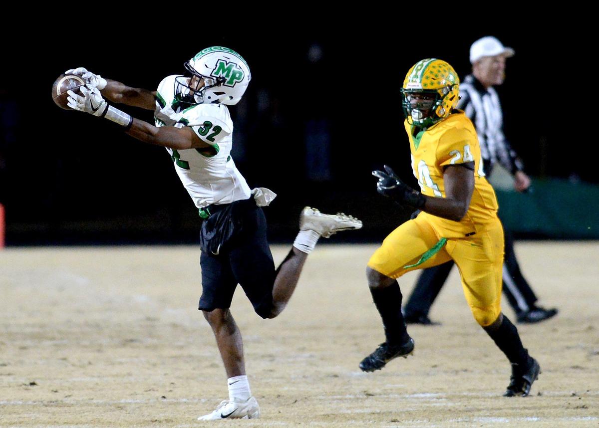 Myers Park Mustangs wide receiver Jordan Bly, left, catches a pass by quarterback Drake Maye during first quarter action against Richmond Senior at Richmond Senior High School in Rockingham, NC on Friday, November 29, 2019. The teams are competing in third round action of the NCHSAA 4AA playoffs.