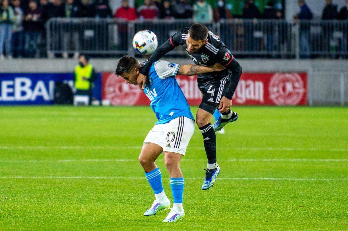 Charlotte FC Christian Ortiz, left, and DC United Brendan Hines-Ike battle for a header during Charlotte FC’s opening match at Audi Field in Washington, D.C, on Saturday, Feb. 26, 2022 . Charlotte FC trailed by 2 goals at the half.
