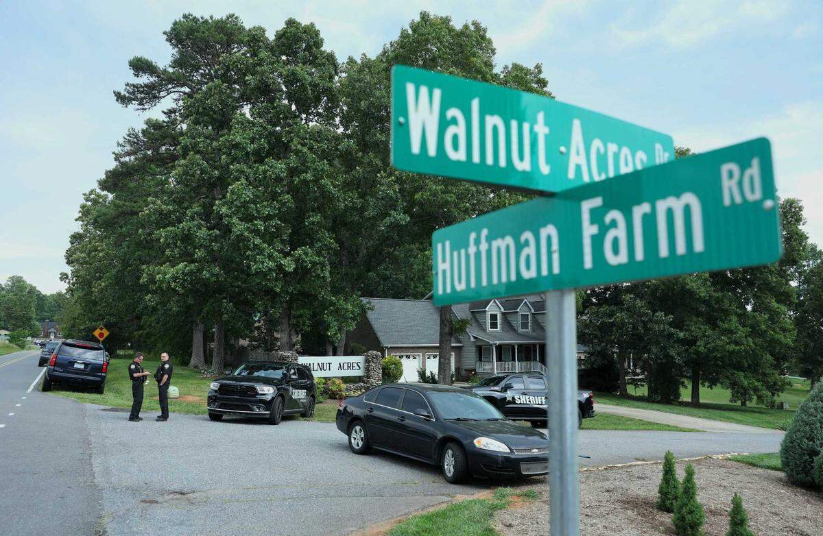 Law officers’ vehicles block the entrance to Walnut Acres Drive in Hickory Sunday, June 1, 2025. An early shooting resulted in 1 dead and 11 wounded
