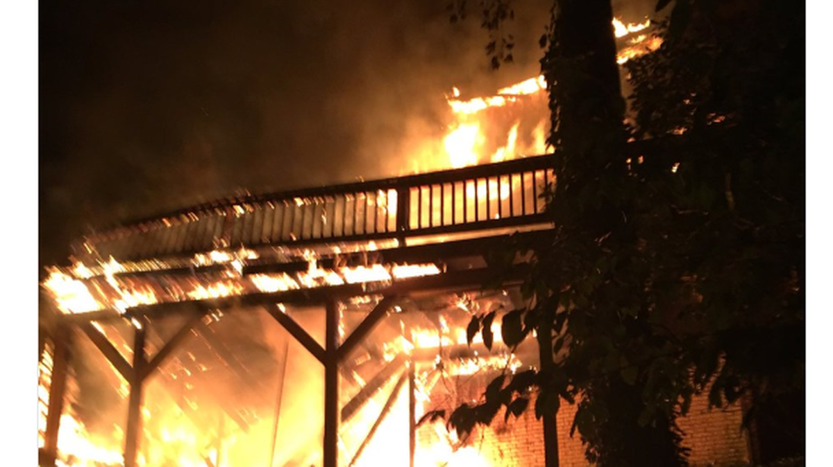 A man sleeping in the 5500-square-foot home says he and four others were able to escape after waking up to the sound of glass breaking.