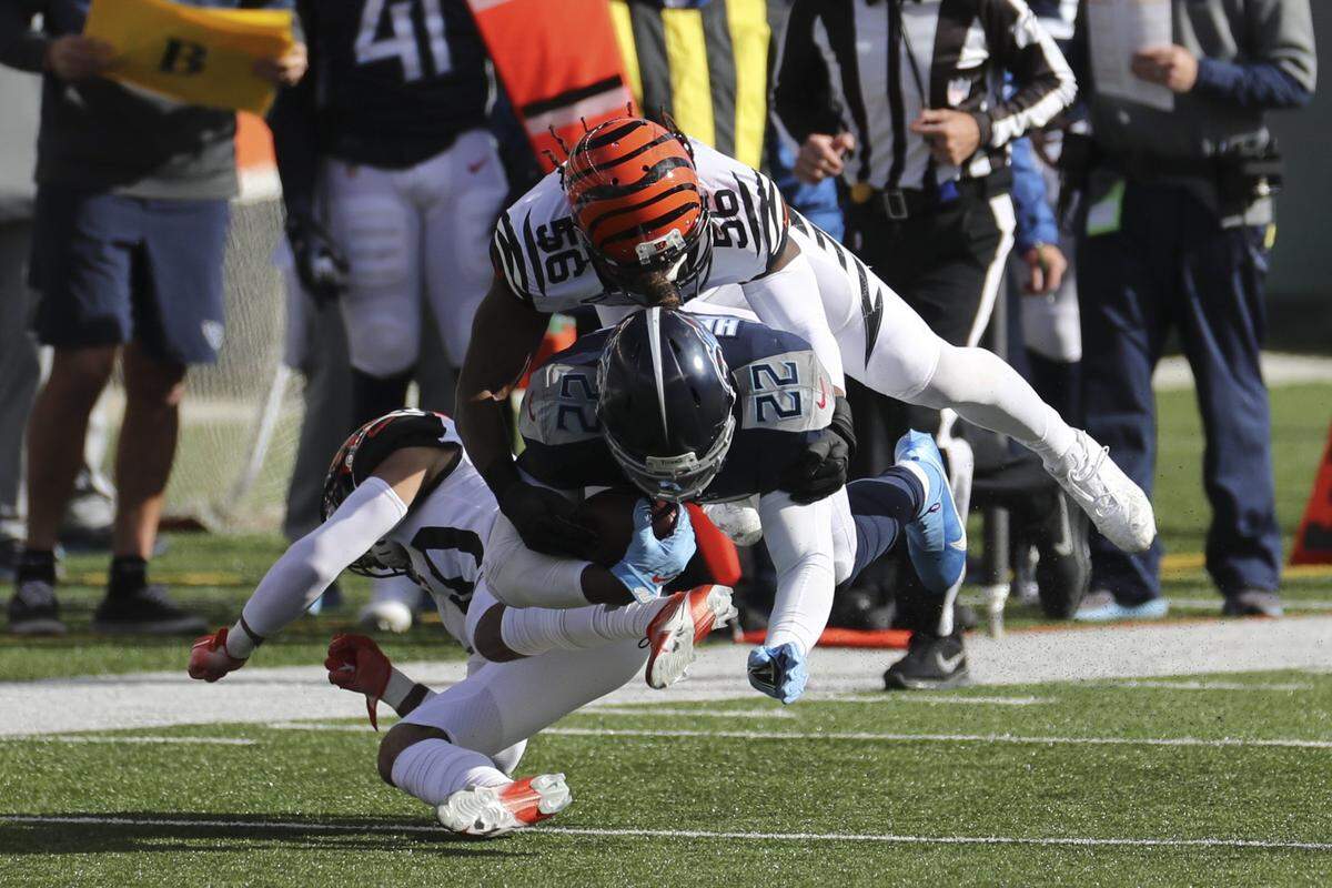 Tennessee Titans’ Derrick Henry (22) is tackled by Cincinnati Bengals’ Josh Bynes (56) during the first half of an NFL football game, Sunday, Nov. 1, 2020, in Cincinnati. (AP Photo/Jay LaPrete)