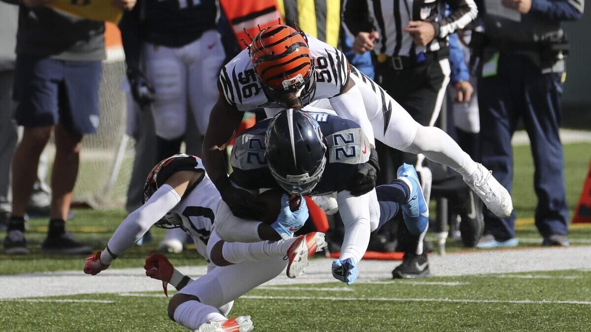 Tennessee Titans running Derrick Henry (22) is tackled by former Cincinnati Bengals’ Josh Bynes (56) last season. Bynes signed with the Panthers.