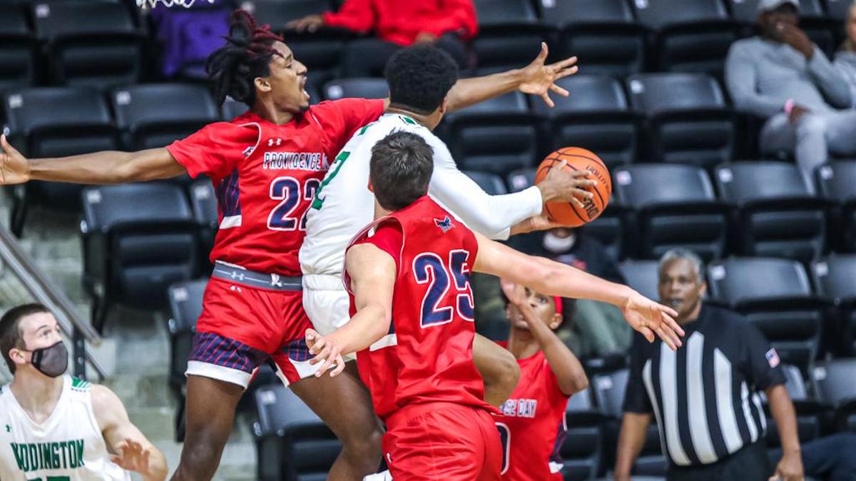 Providence Day’s Bryce Scott (22) and Riley Allenspach (25) defend as Weddington’s Chase Lowe drives to the hoop.
