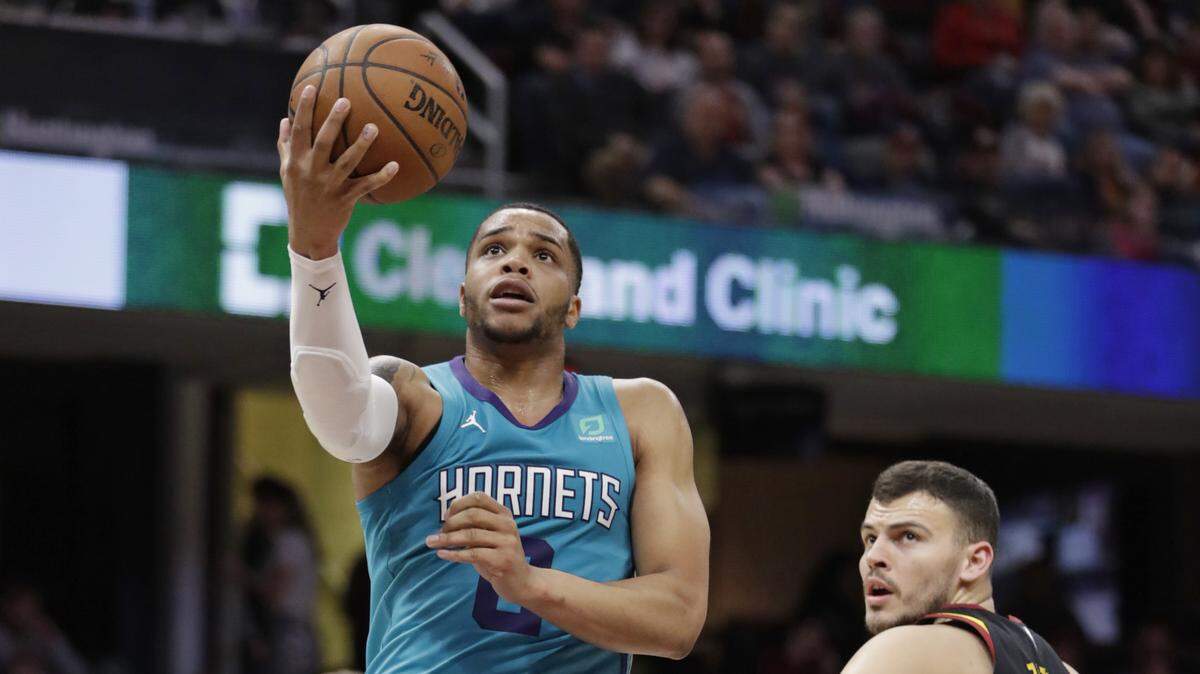 Charlotte Hornets rookie Miles Bridges, left, drives past the Cavaliers’ Ante Zizic toward the basket during the second half Tuesday in Cleveland. Charlotte won 124-97.