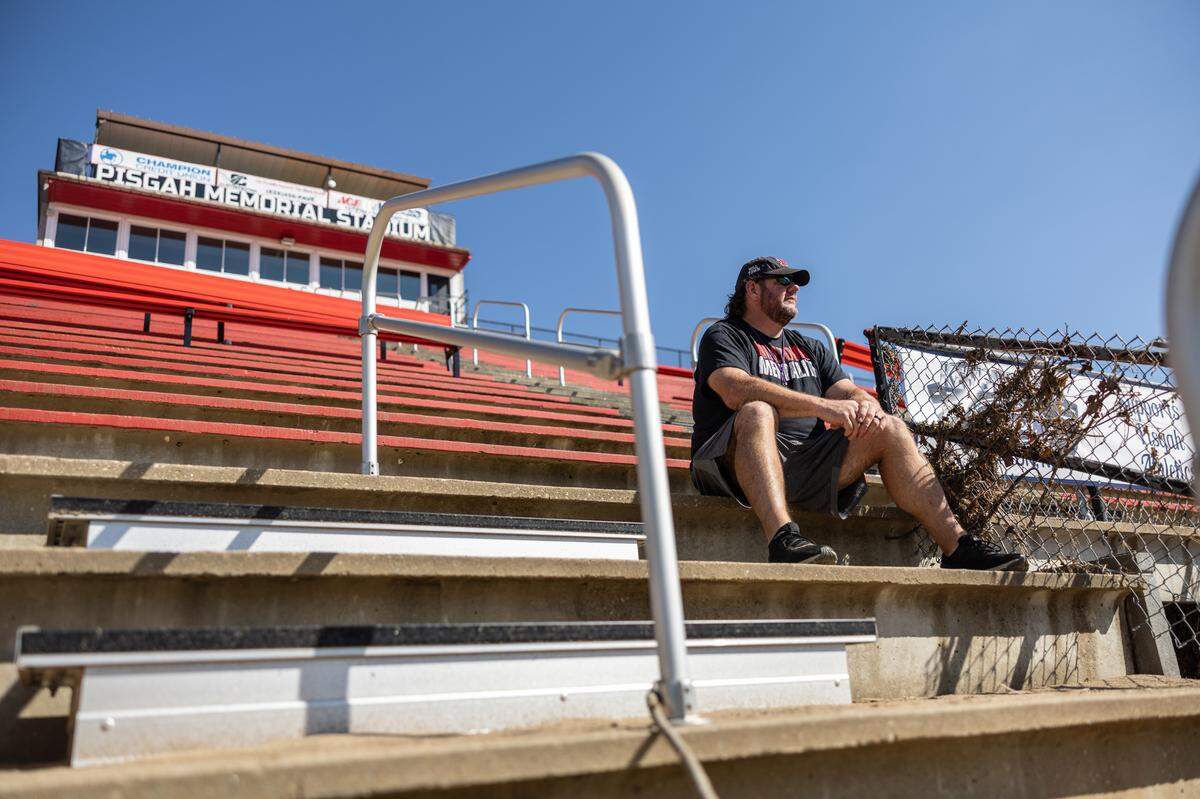 Jody Mathis sits in the stands of the football stadium that was flooded during hurricane Helene at Pisgah High School in Canton, N.C. on Tuesday, October 8, 2024.