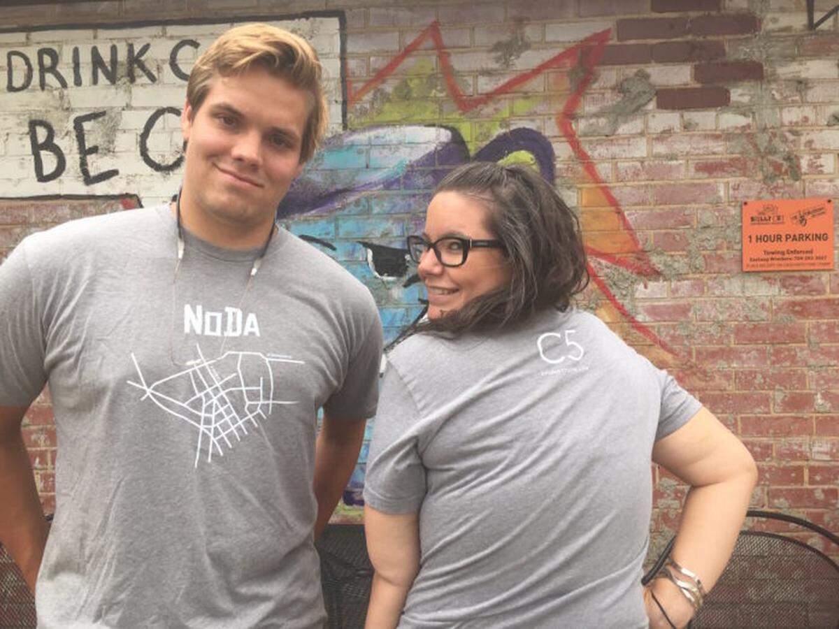 The front and back of the NoDa shirt, as modeled by our resident NoDa-ites, Tyler Blackshaw and Katie Coleman.
