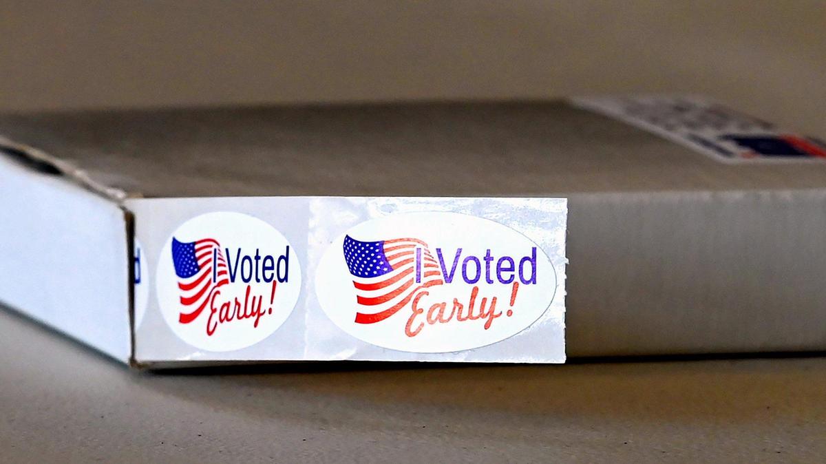 A sticker is given to voters during early voting for the NC primaries on Thursday, April 28, 2022.