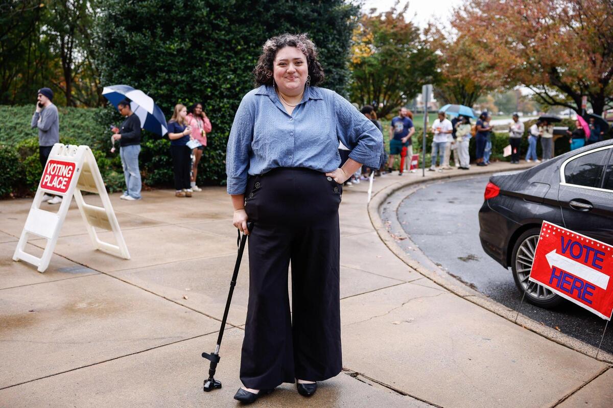 Poll worker Kate Cruz poses outside the Charlotte Mecklenburg Library in University City where she is volunteering on election day in Charlotte, NC on November 5, 2024.