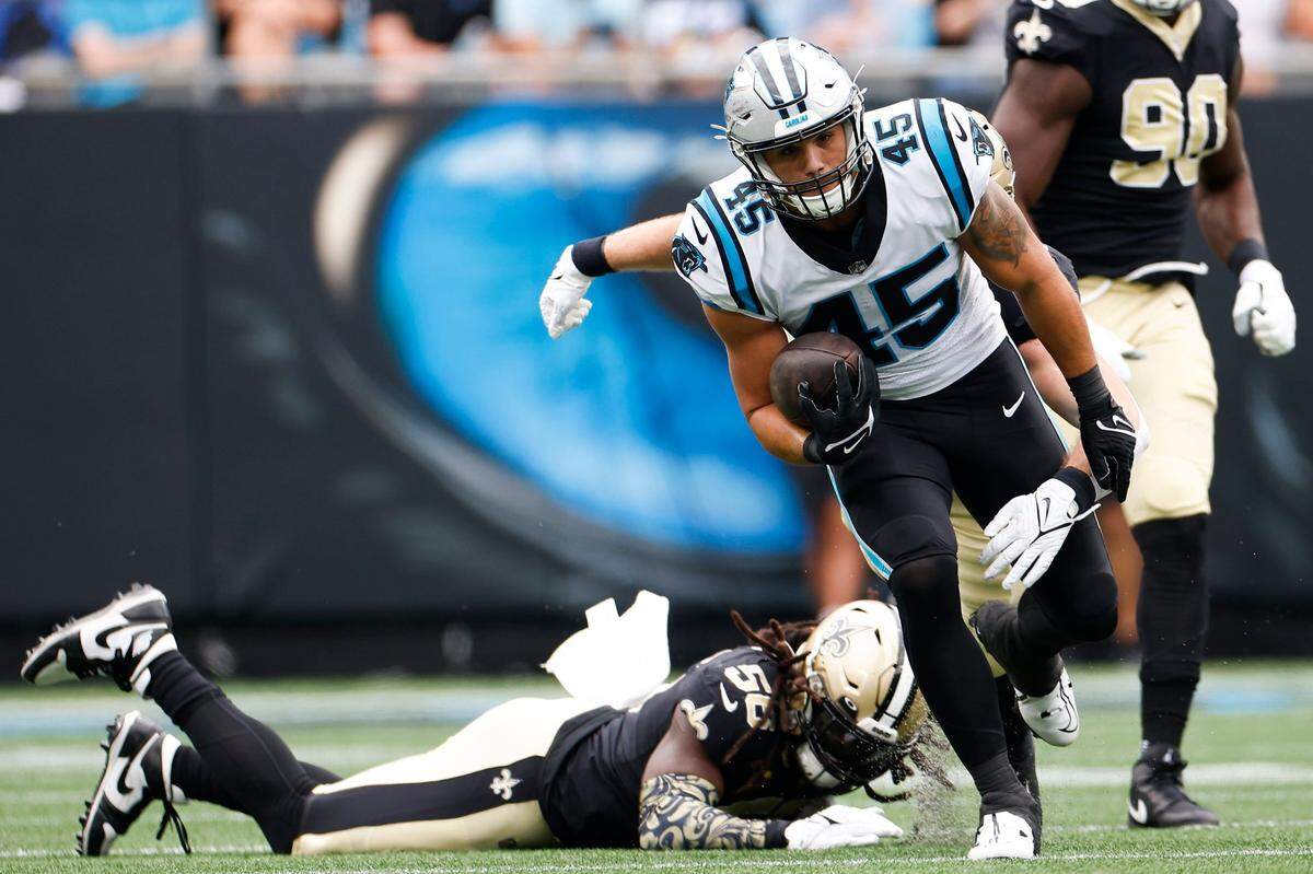 Carolina Panthers fullback Giovanni Ricci (45) runs the ball around New Orleans Saints linebacker Demario Davis (56) during a game at Bank of America Stadium in Charlotte, N.C., Sunday, Sept. 25, 2022.