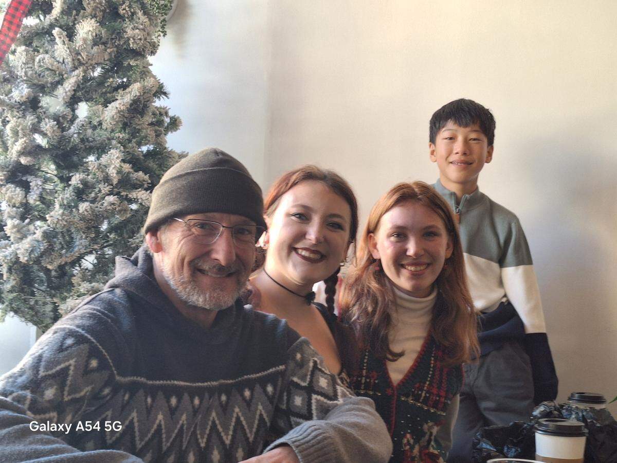 Richard Sexton of Concord relaxed with daughters Amelia, 18, Claire, 21, and son, Daniel, 13, at Press and Porter Coffeehouse in downtown Concord on Saturday, Nov. 30, 2024.