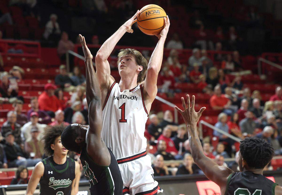 Davidson Wildcats forward Reed Bailey, right, releases a shot over William Peace forward/center Chuks Ezeonu, left, during action on Monday, November 4, 2024.