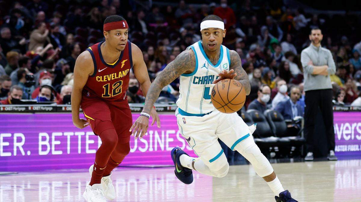 Charlotte Hornets’ Isaiah Thomas (4) drives around Cleveland Cavaliers’ Tim Frazier (12) during the second half of an NBA basketball game, Wednesday, March 2, 2022, in Cleveland. The Hornets won 119-98. (AP Photo/Ron Schwane)