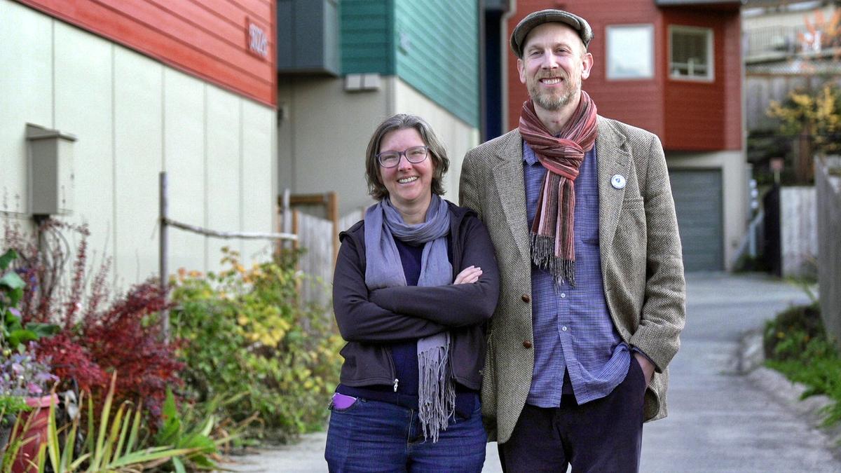 Susan Zeman and Bob Downing stand in front of their Seattle townhouse they purchased in 2016 through the Homestead Community Land Trust. Land trusts offer affordable homeownership by separating the ownership of the house and the land beneath it. Because of Seattle’s increasingly expensive housing market, the couple said owning a home wouldn’t be possible without the program.