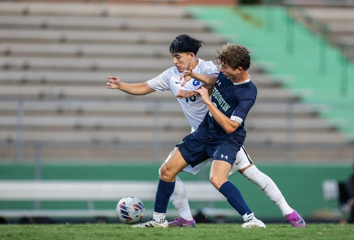 Garinger Wildcats Eduin Yohel, back, collides with Weddington Warriors Owen Carter at Weddington High School in Matthews, N.C., on Wednesday, August 28, 2024.