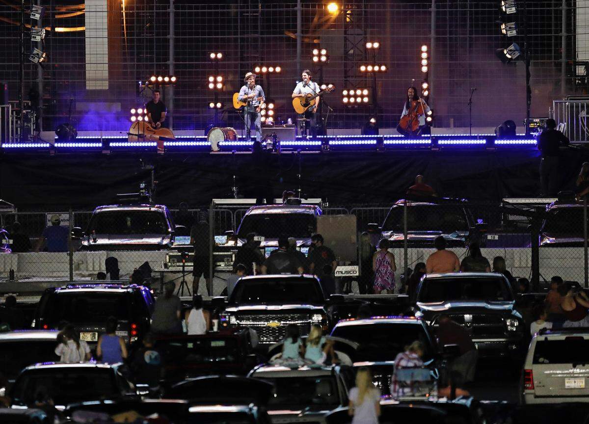 The Avett Brothers perform at Charlotte Motor Speedway in a drive-in-style setting on Saturday night.