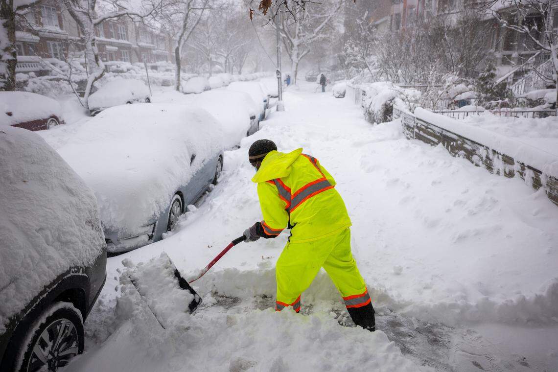 NEW YORK CITY - FEBRUARY 23: People shovel snow in the streets of Brooklyn as blizzard conditions continue on February 23, 2026 in New York City. New York City Mayor Zohran Mamdani announced a state of emergency yesterday for New York City and issued a travel ban until 12 p.m. on Monday. New York City is expecting well over a foot of snow in what has become one of the largest winter storms in the city's history. (Photo by Spencer Platt/Getty Images)