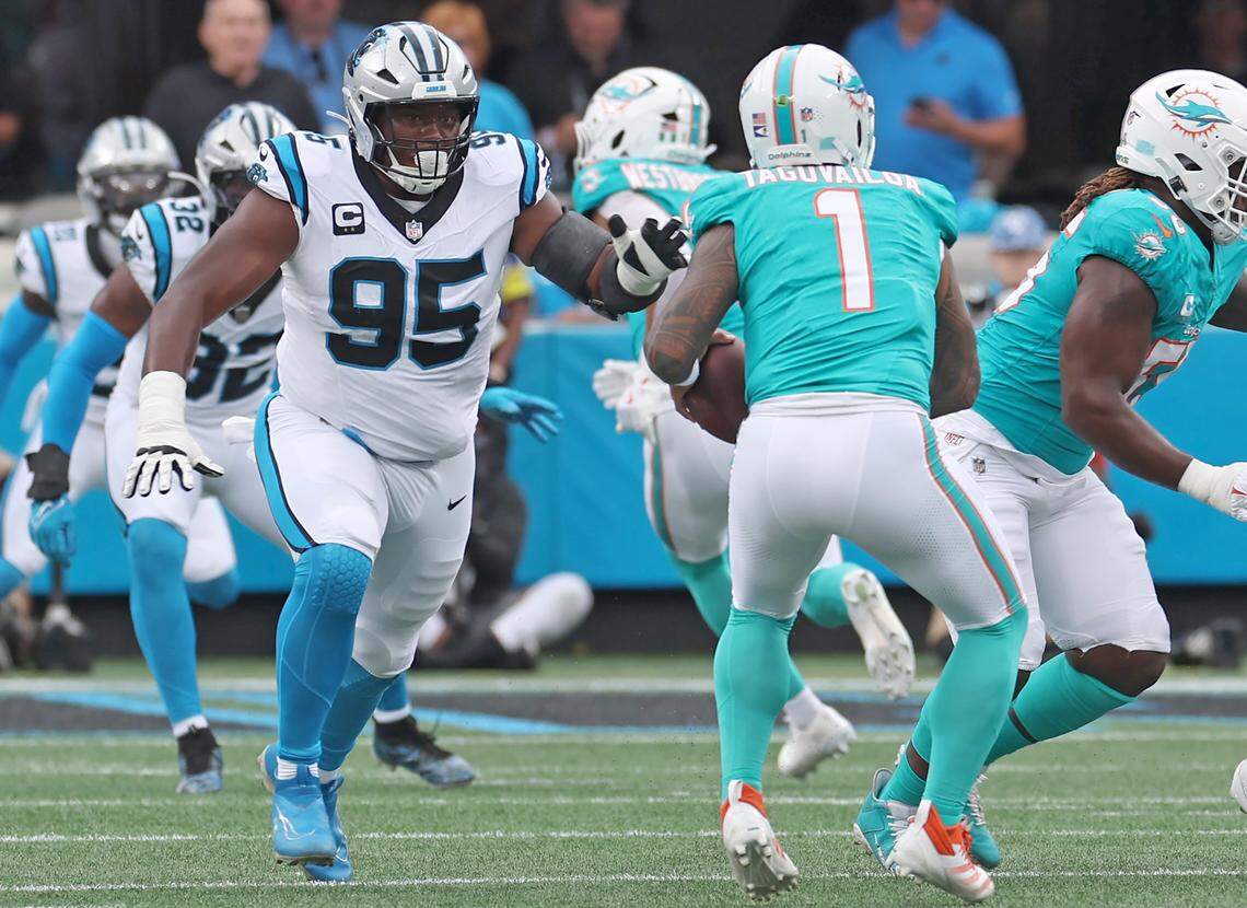 Carolina Panthers defensive end Derrick Brown, left, rushes Miami Dolphins quarterback Tua Tagovailoa, right, to make a sack on Sunday, October 5, 2025 at Bank of America Stadium in Charlotte, NC. The Panthers defeated the Dolphins 27-24.  