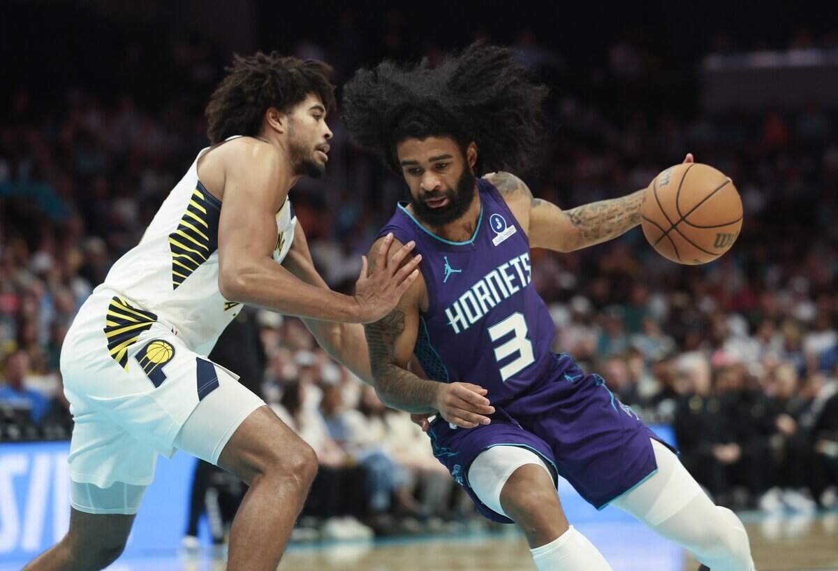 Charlotte Hornets guard Coby White drives to the basket against Indiana Pacers guard Ethan Thompson during the game Friday, April 3, 2026 at Spectrum Center in Charlotte.