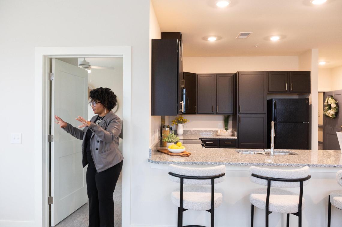 Christina Bruce gives a tour of a model unit at Evoke Living at Eastland Yards which is an an affordable housing complex for seniors in Charlotte, N.C., on Wednesday, November 20, 2024.