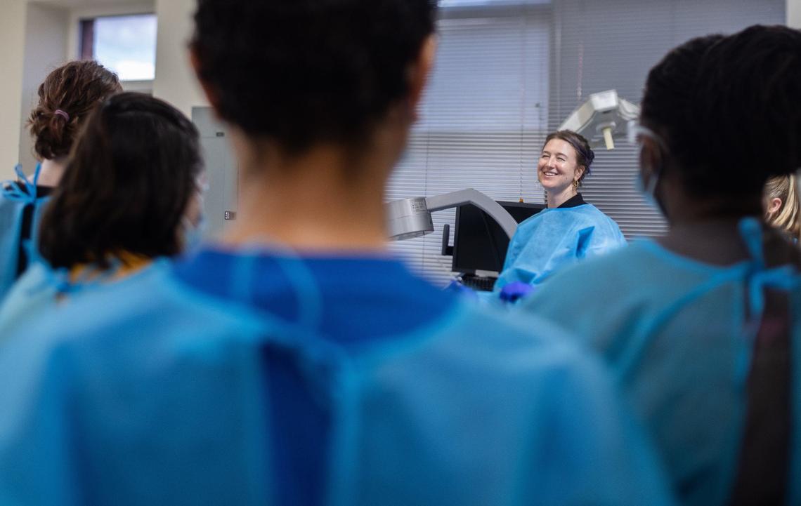 Fauna Moore leads a crowd of participants eager to learn about the human body during Dissection Club at Experience Anatomy.