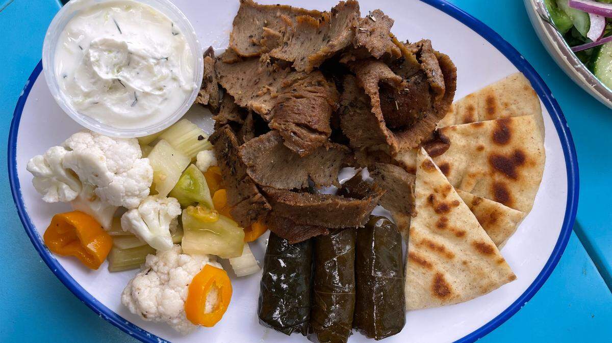 Ilios Crafted Greek’s lamb with grape leaves, vegetables and a side of tzatziki.