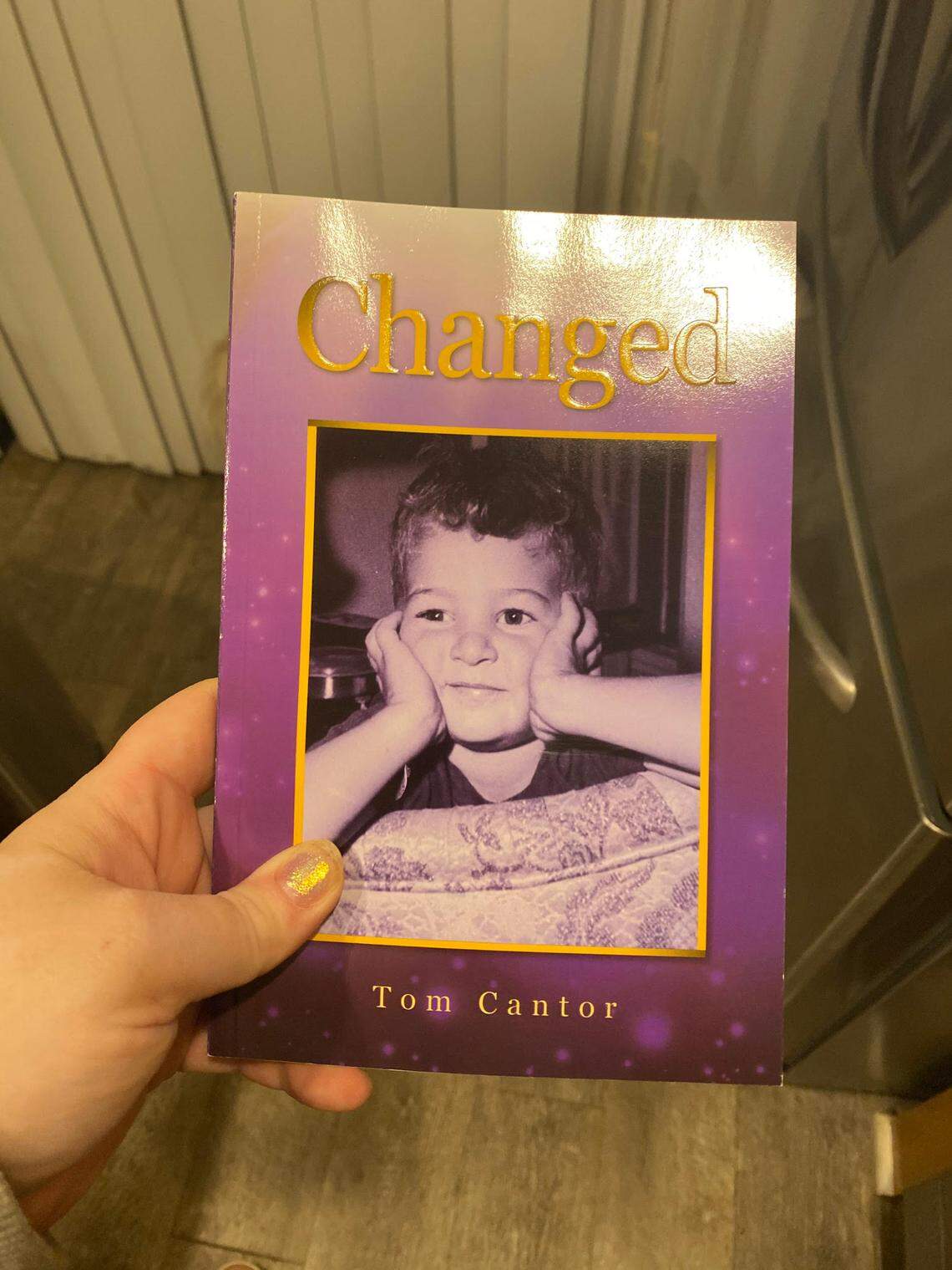Heather Mirman holding a copy of “Changed” by Tom Cantor, which is a book aimed at proselytizing Jewish residents to Christianity.
